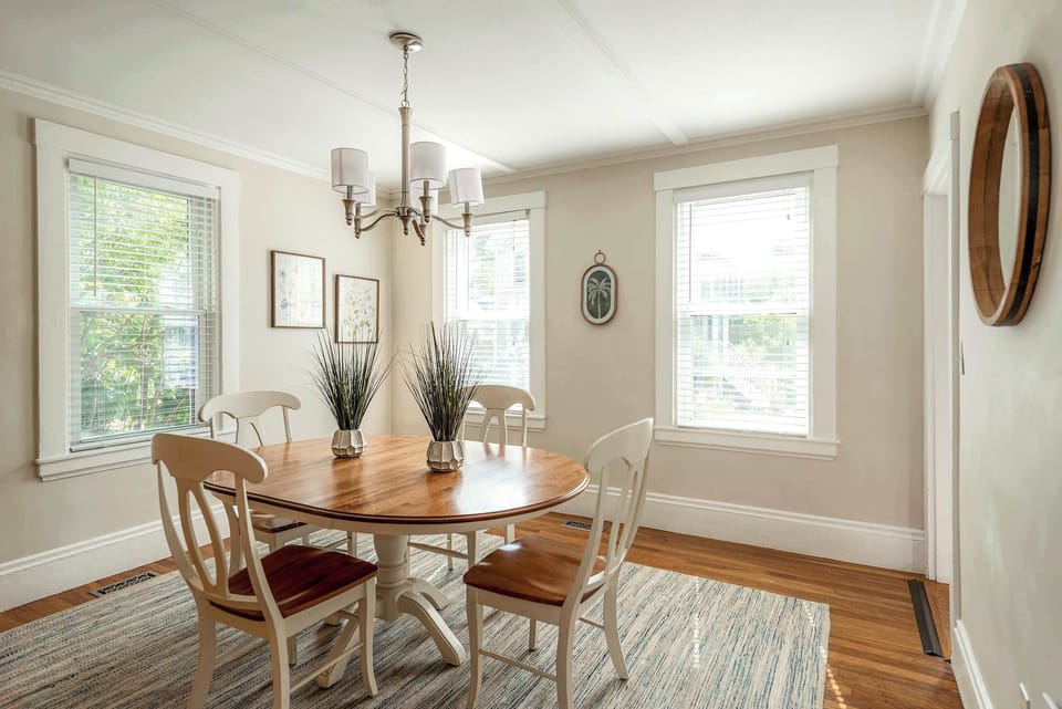 Elegant dining room with natural wood table and chandelier