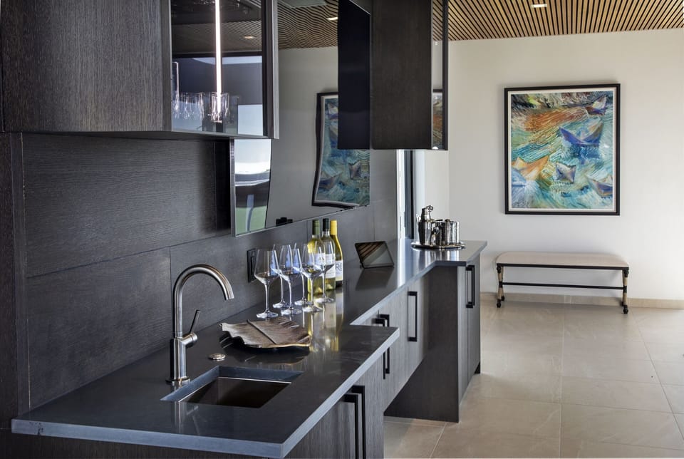 Just under the massive living room TV is the wet bar with sink, ice maker and fridge. It makes drink refills when you're lounging in the hot tub a breeze!