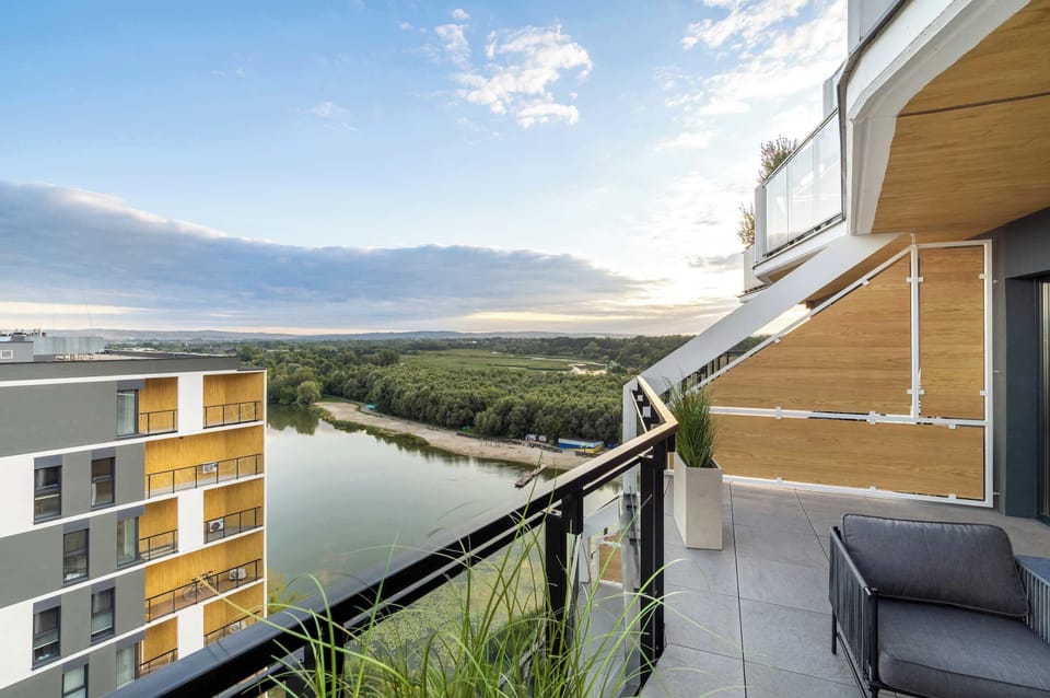 Furnished balcony with green surroundings. 
