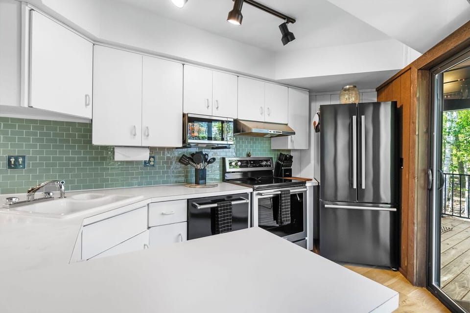 Bright modern kitchen with stainless appliances and storage