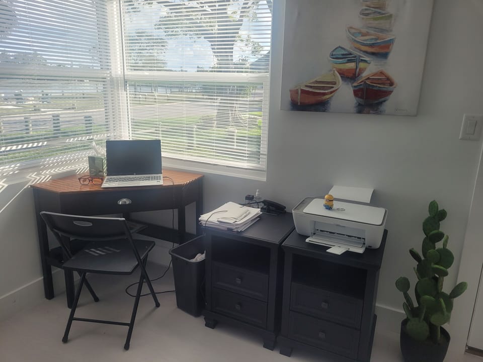 Corner desk/workspace with printer and gorgeous water views.