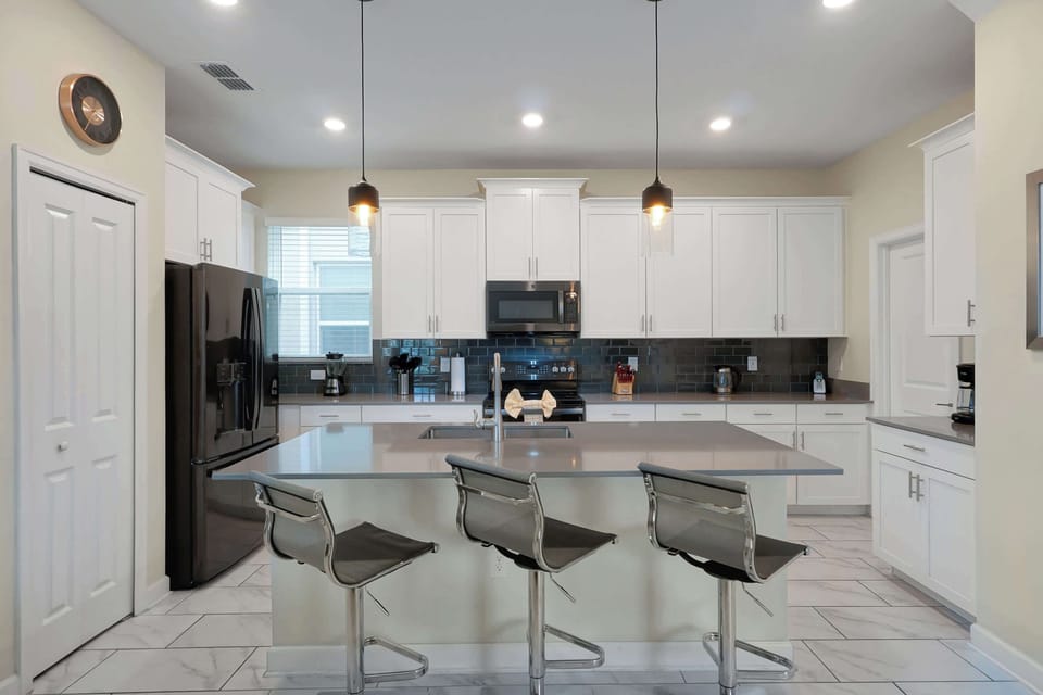 Sleek chef’s kitchen with oversized island 