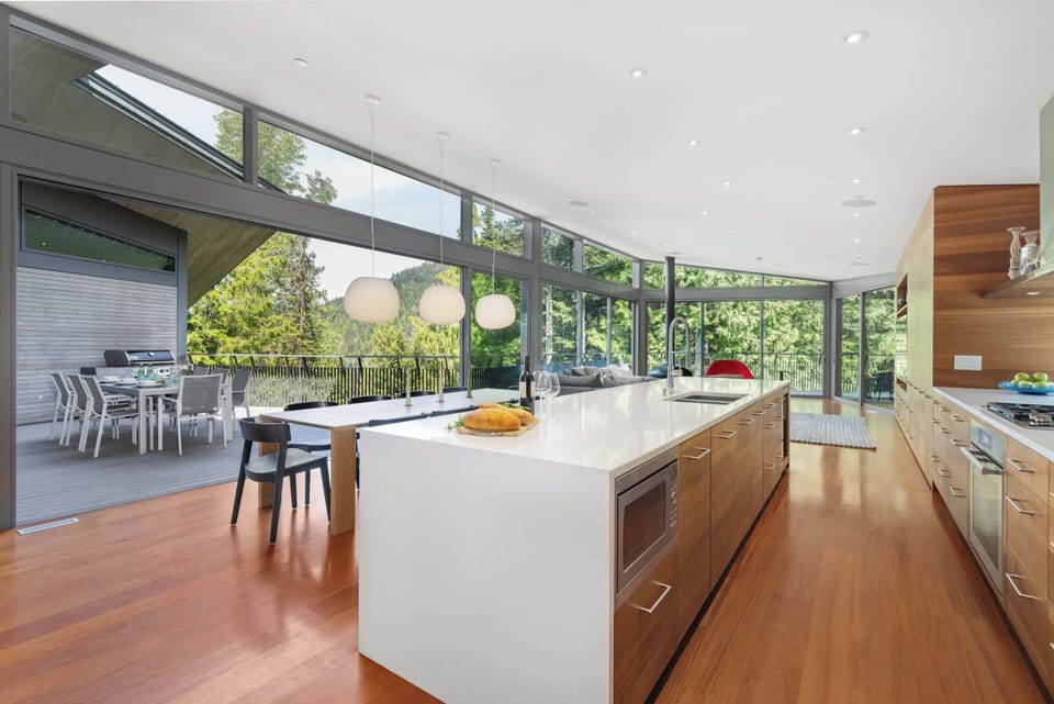 - Bright open kitchen flowing into living and dining space  
- Large island perfect for meals and morning gatherings  
- Natural wood warmth meets scenic mountain views  