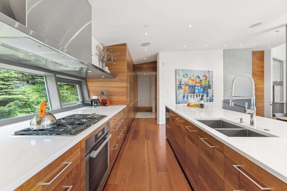 - Modern kitchen with sleek countertops and wood cabinetry  
- Fully equipped with premium appliances and forest views  
- Designed for culinary creativity in a serene setting  
