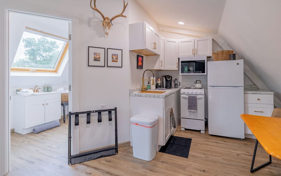 The kitchenette has a fridge, oven/stove, microwave, coffee maker and more.