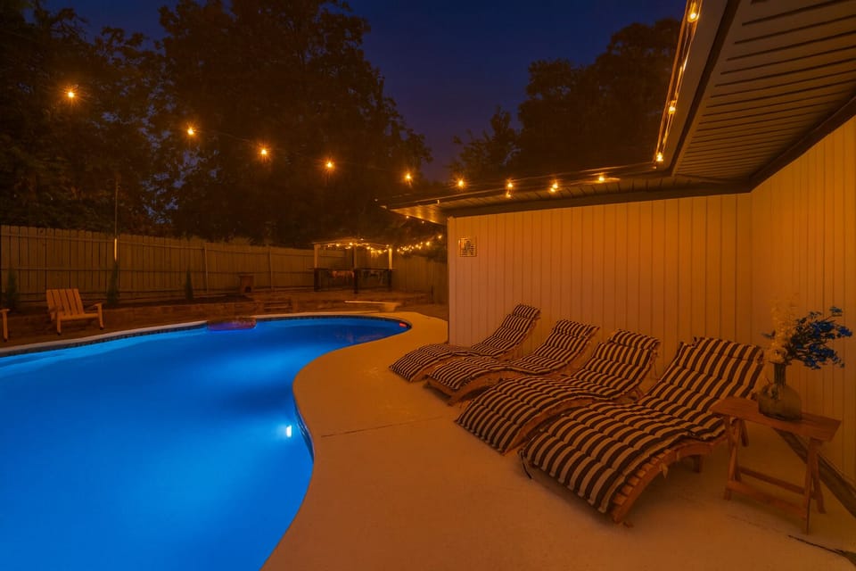 Night time by the pool in the backyard