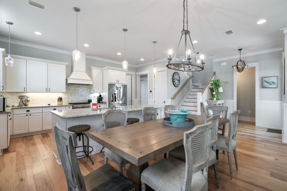 Fully equipped modern kitchen with high-end appliances and an adjoining dining area.