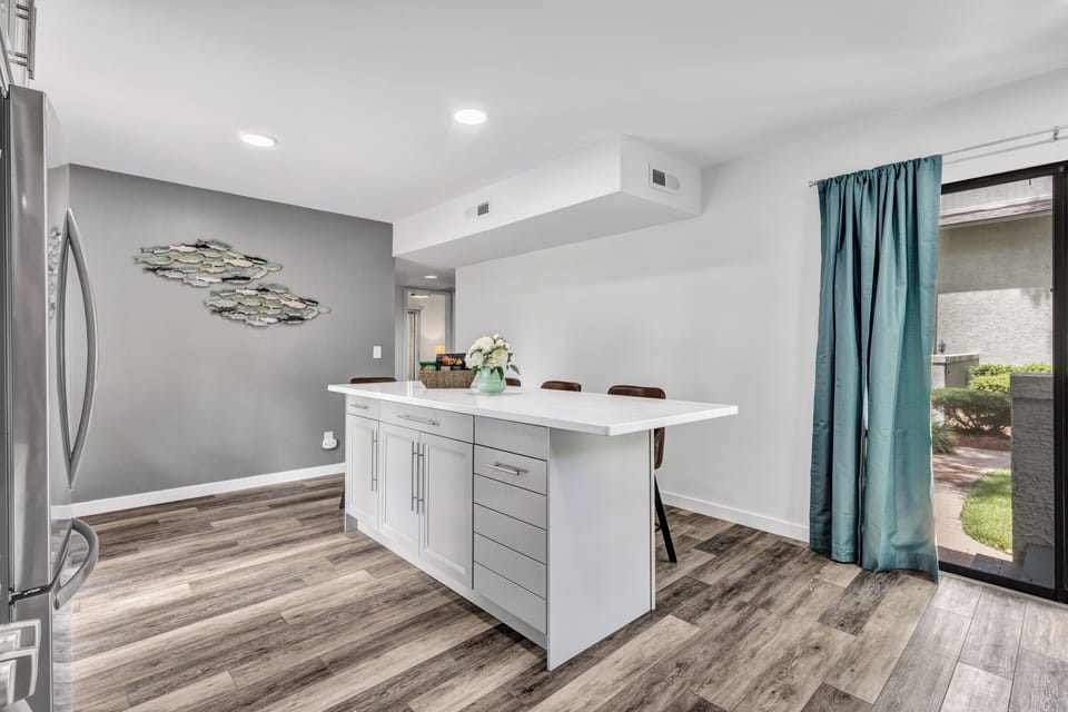 Cook up delicious meals in the modern kitchen featuring sleek finishes, top-quality appliances, plenty of counter space, and kitchen island with additional seating for 4.