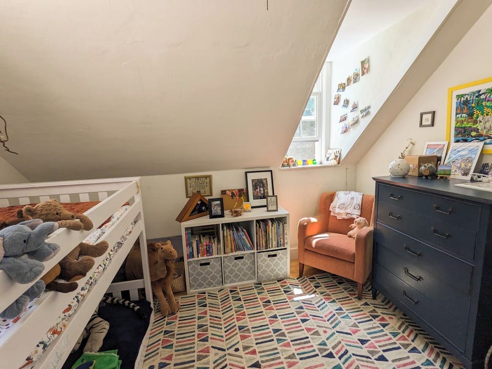 Child's room with bunk beds and armchair for bedtime stories.