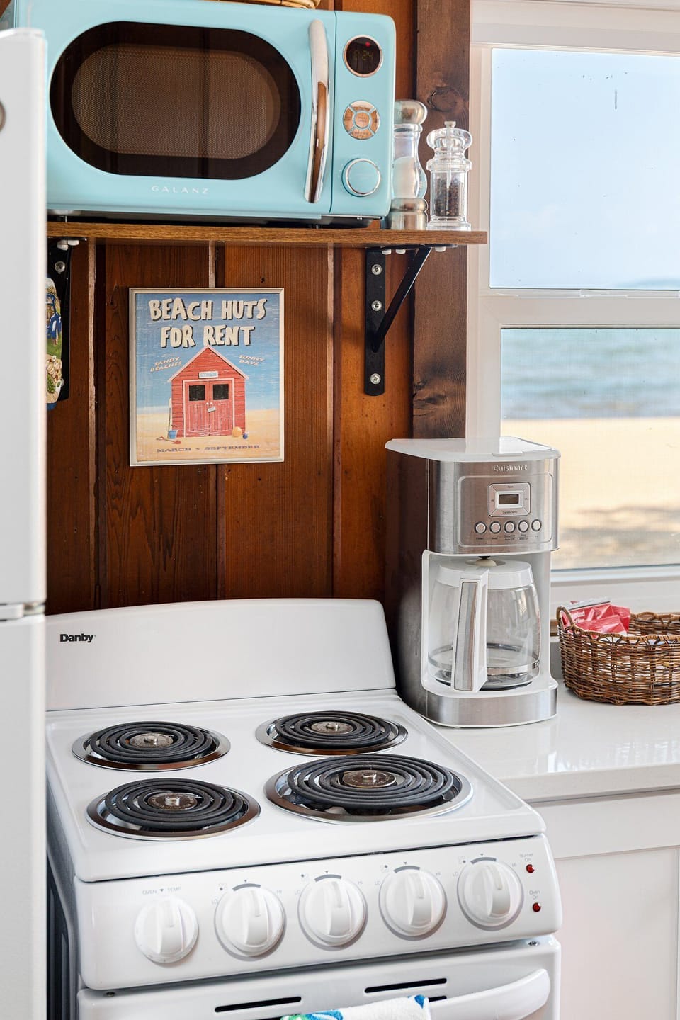 Retro-style stove & coffee maker add charm to this beachy kitchen corner.