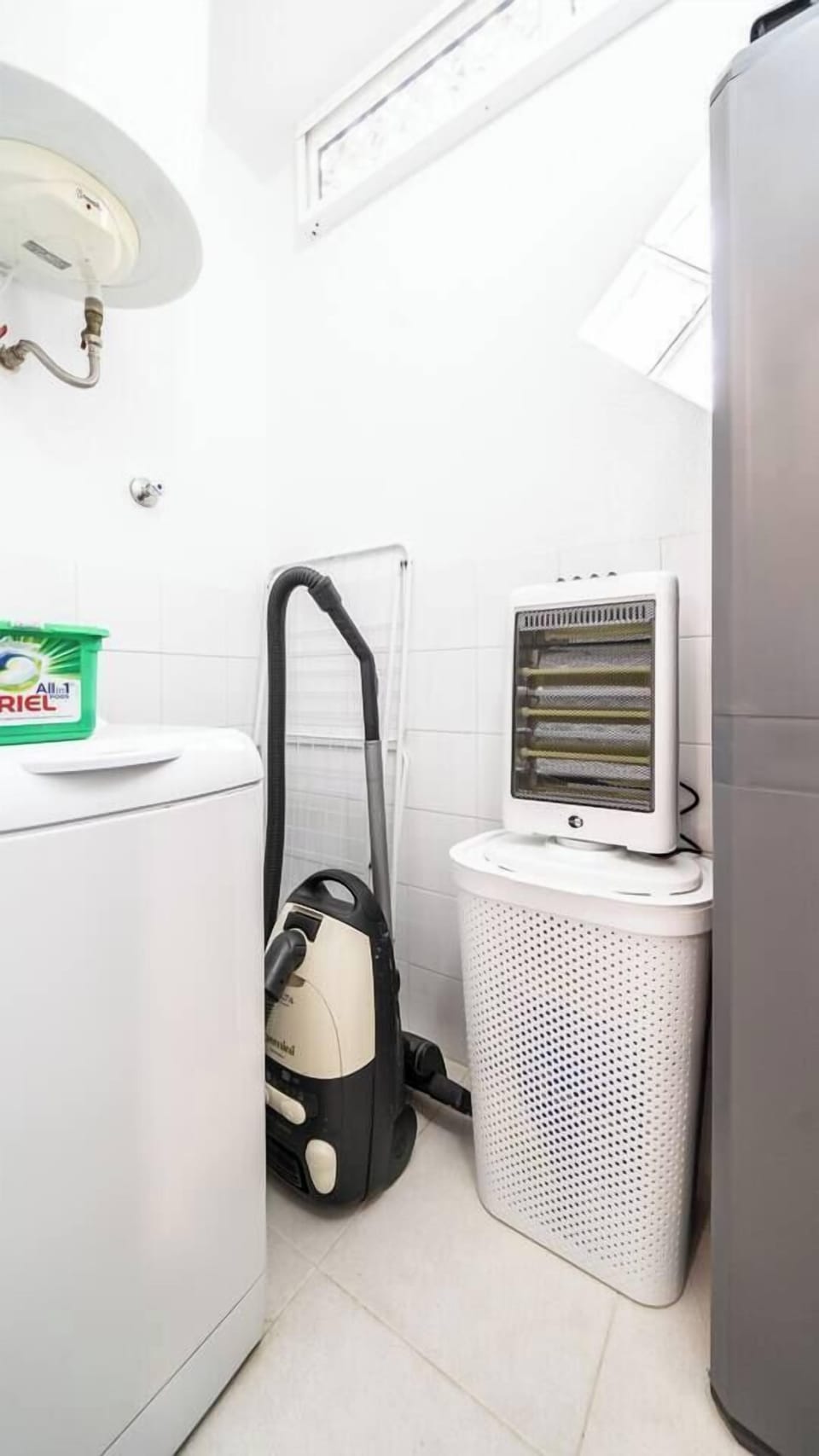 The washing machine, dishwasher, and vacuum cleaner are all stocked in the utility room. 
