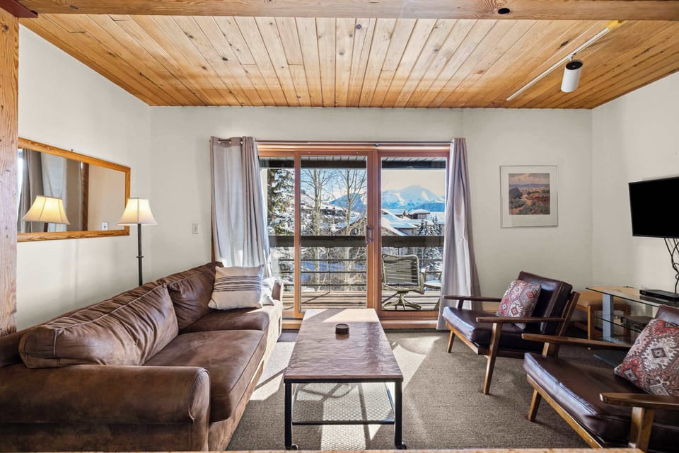 Living room with balcony and Mountain Views Pull out sofa  | Listed with @BookTraverse