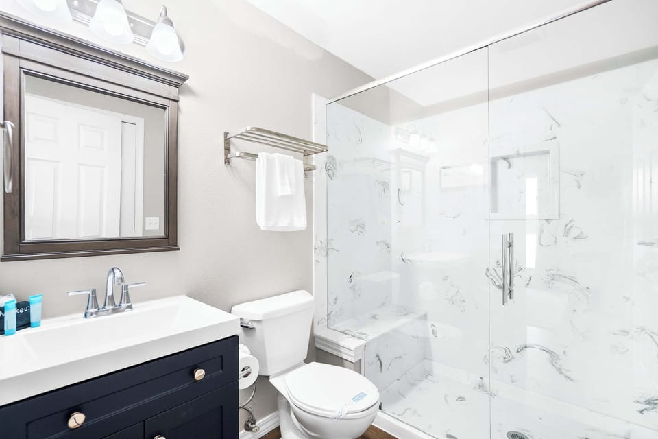 Wash up in the king ensuite, featuring a single vanity & glass shower​