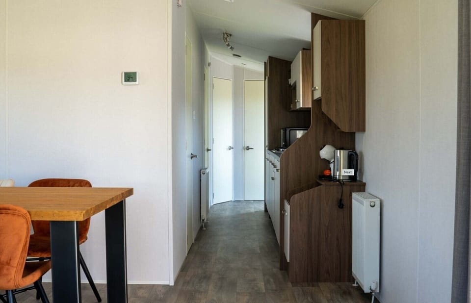 Dining table and kitchen at Vakantiepark de Zeeuwse Parel - Sunset