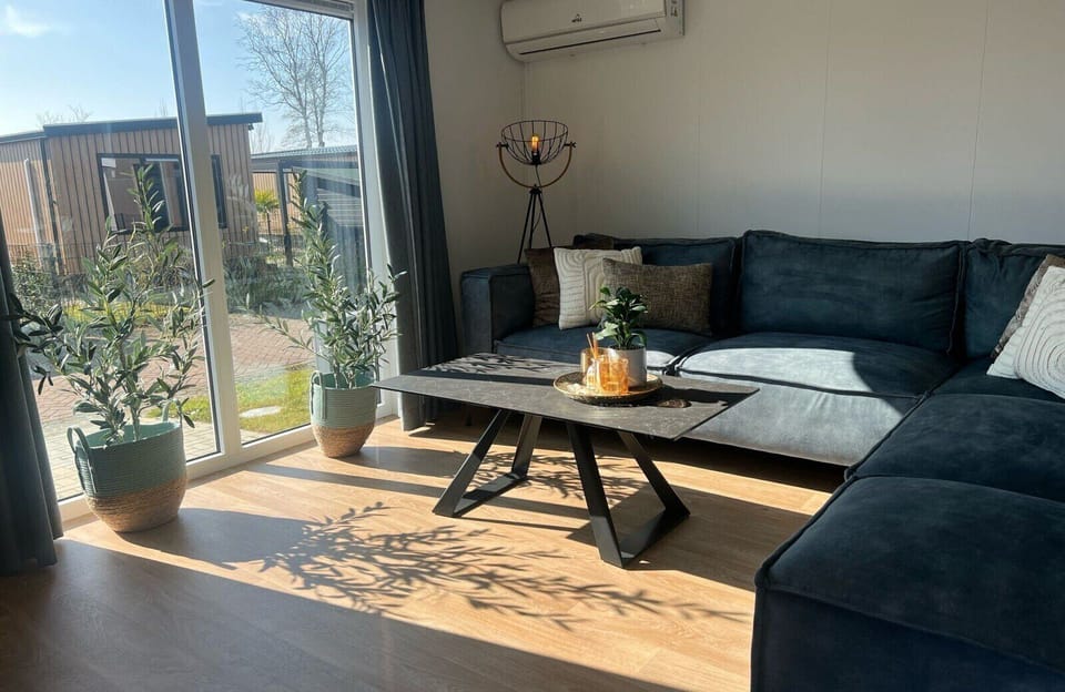 Living room with sofa at Vakantiepark de Zeeuwse Parel - Zeebaars