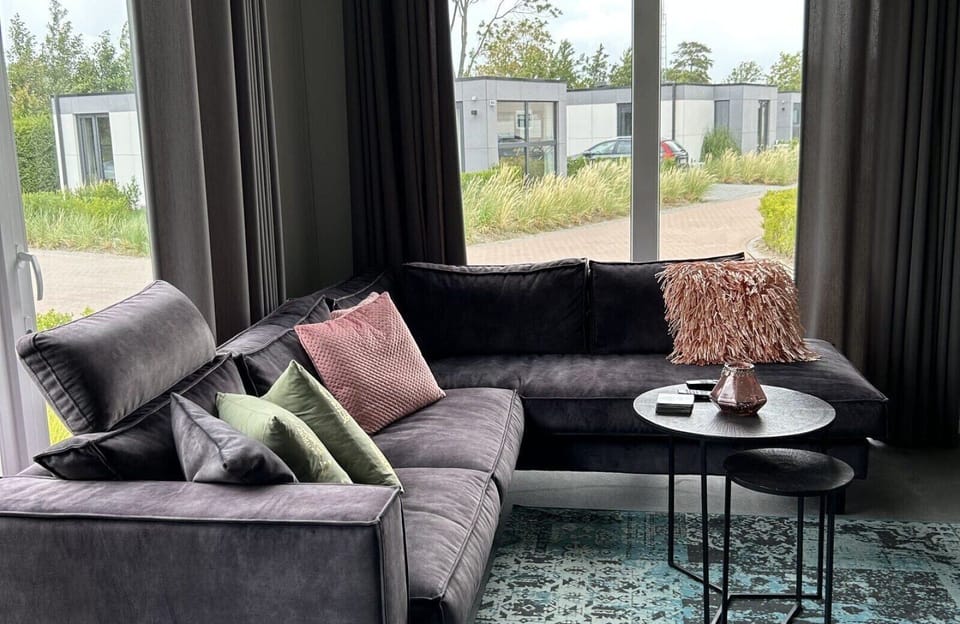 Living room with sofa at Vakantiepark de Zeeuwse Parel - North Sea Deluxe