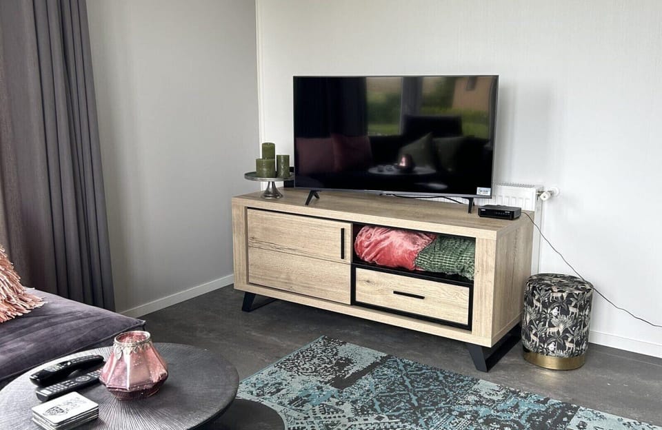 Living room with TV at Vakantiepark de Zeeuwse Parel - North Sea Deluxe