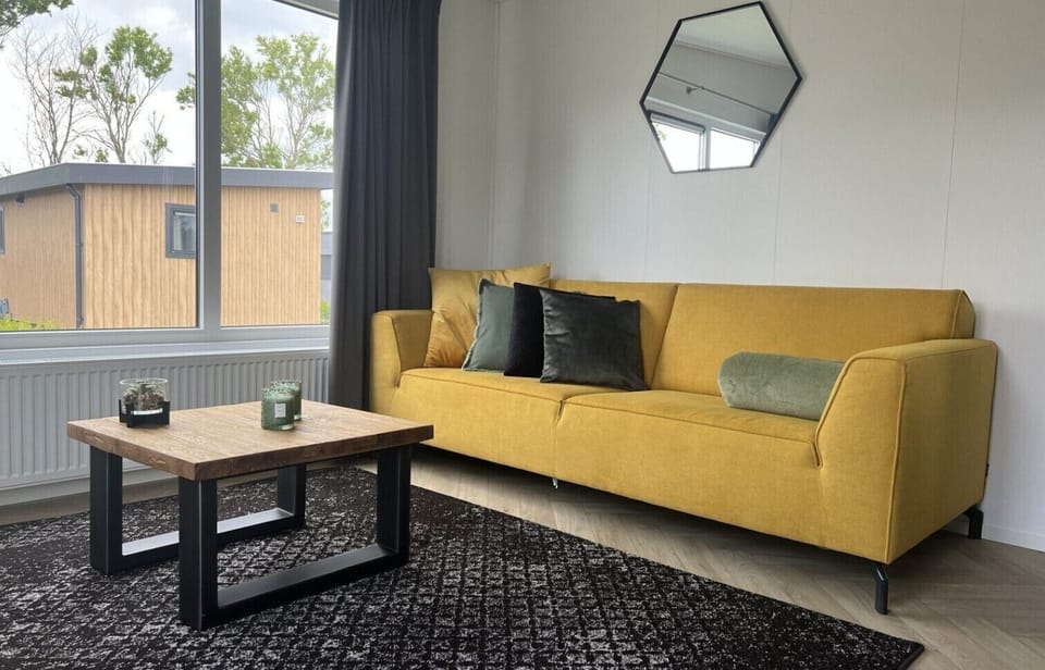 Living room with sofa and coffee table at Vakantiepark de Zeeuwse Parel - Oosterschelde