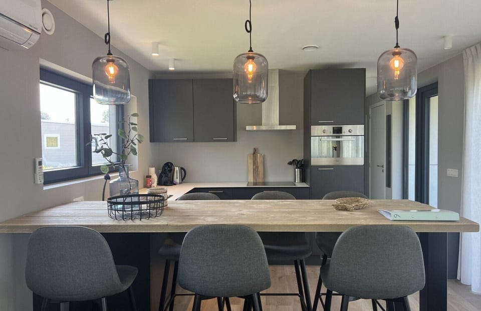 Dining table and kitchen at Vakantiepark de Zeeuwse Parel - de Zeebries