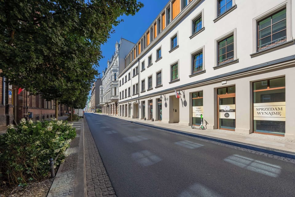 Contemporary street view with modern façades and wide sidewalks.