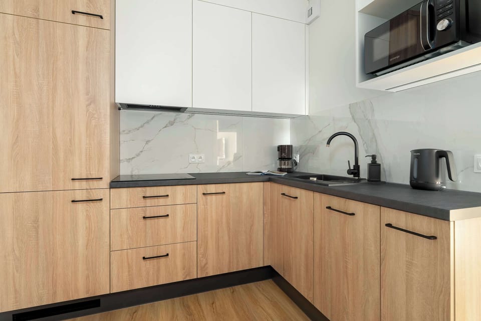 The kitchen's sleek design includes all necessary cookware and utensils.