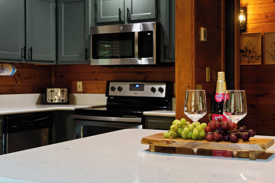Rustic-modern kitchen with island seating and stainless steel appliances