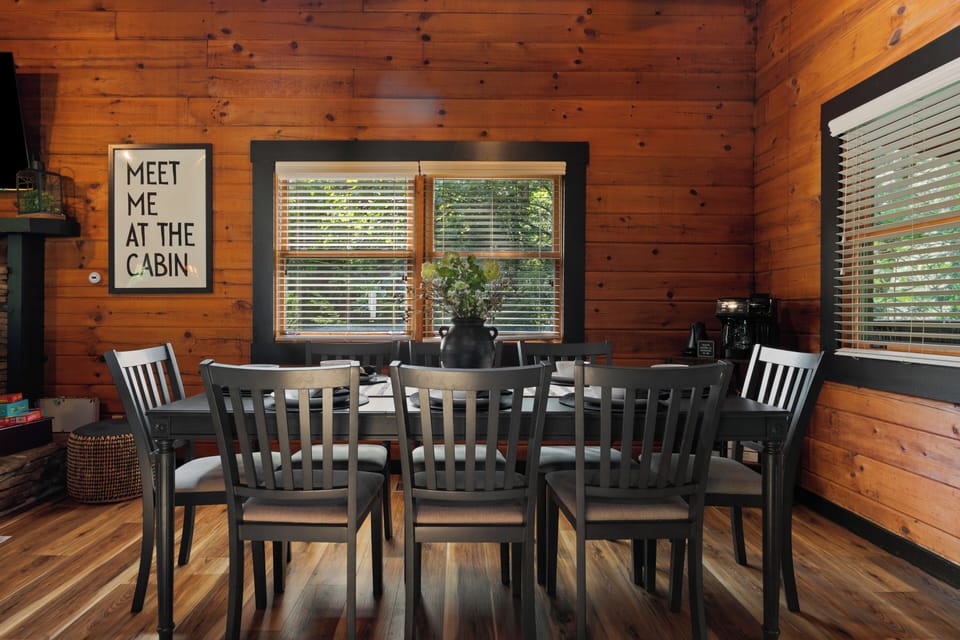 Cozy cabin dining for six with natural light and rustic charm