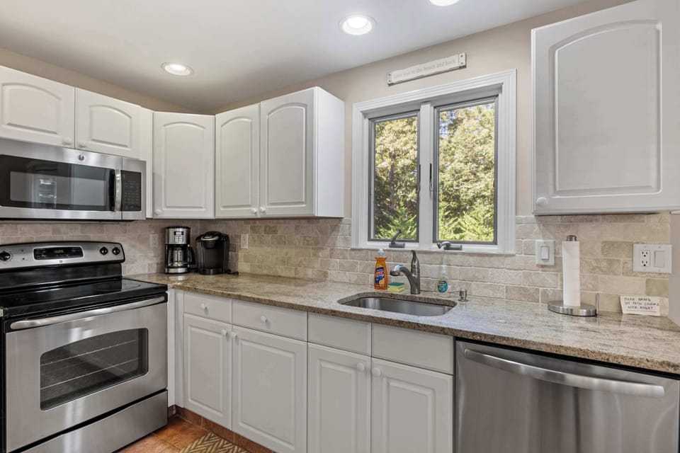 Fully stocked kitchen with stainless steel appliances and everything needed for home-cooked meals