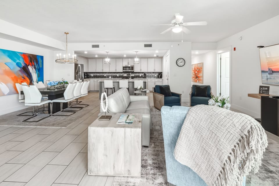 Unwind in your spacious open-concept living space, where modern comfort meets coastal style with plush seating and a fully-equipped kitchen.