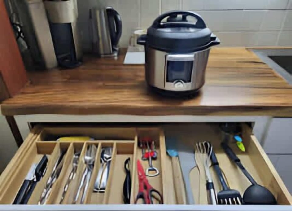 Utensils and a Keurig and a hotpot provided as well as a hotplate.