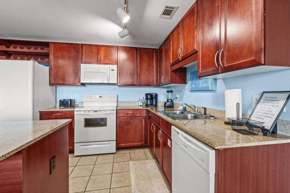 Fully equipped kitchen featuring granite countertops, modern appliances, and plenty of cabinet space.