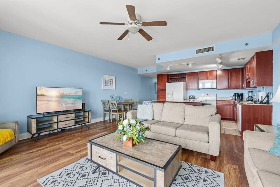 Cozy Gathering Space – Plush sofas, a queen-size sleeper sofa, stylish décor, and a large TV perfect for relaxing after a day at the beach.