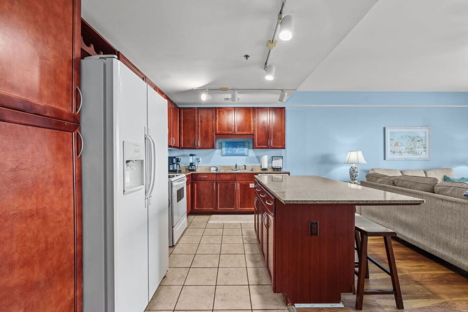 Fully equipped kitchen featuring granite countertops, modern appliances, and plenty of cabinet space.