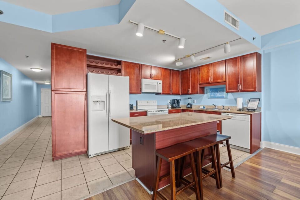 Fully equipped kitchen featuring granite countertops, modern appliances, and plenty of cabinet space.