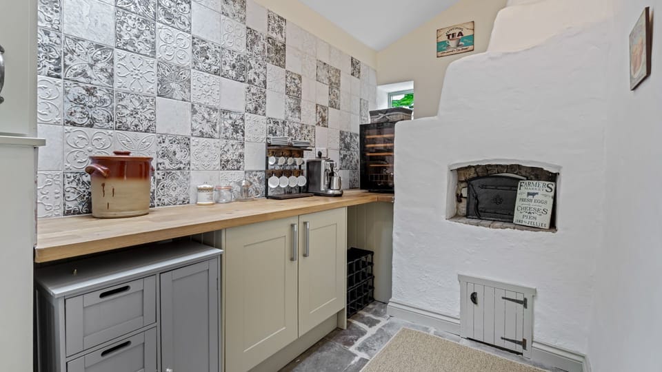 At the back of the property, the pantry area offers extra worktop space, a coffee machine and a wine fridge, and even features an original bread oven dating back to the 18th century.