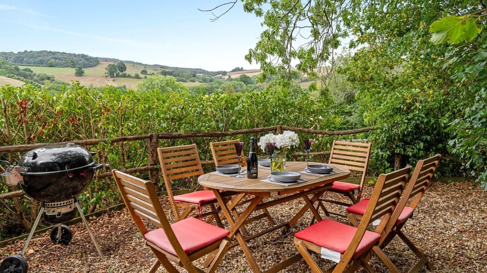 Outside, a garden with beautiful open views invites you to relax and watch the changing light over the hills.