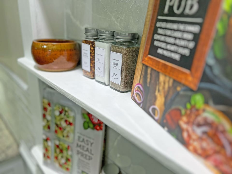 Kitchen nook with a variety of spices & handy cook books