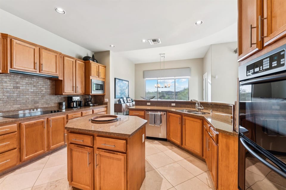 Modern kitchen with granite countertops and stainless steel appliances.