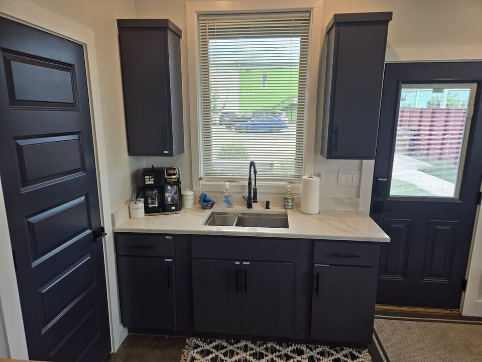 Coffee pot and keurig combo. Large sink. Cooking and cleaning supplies.