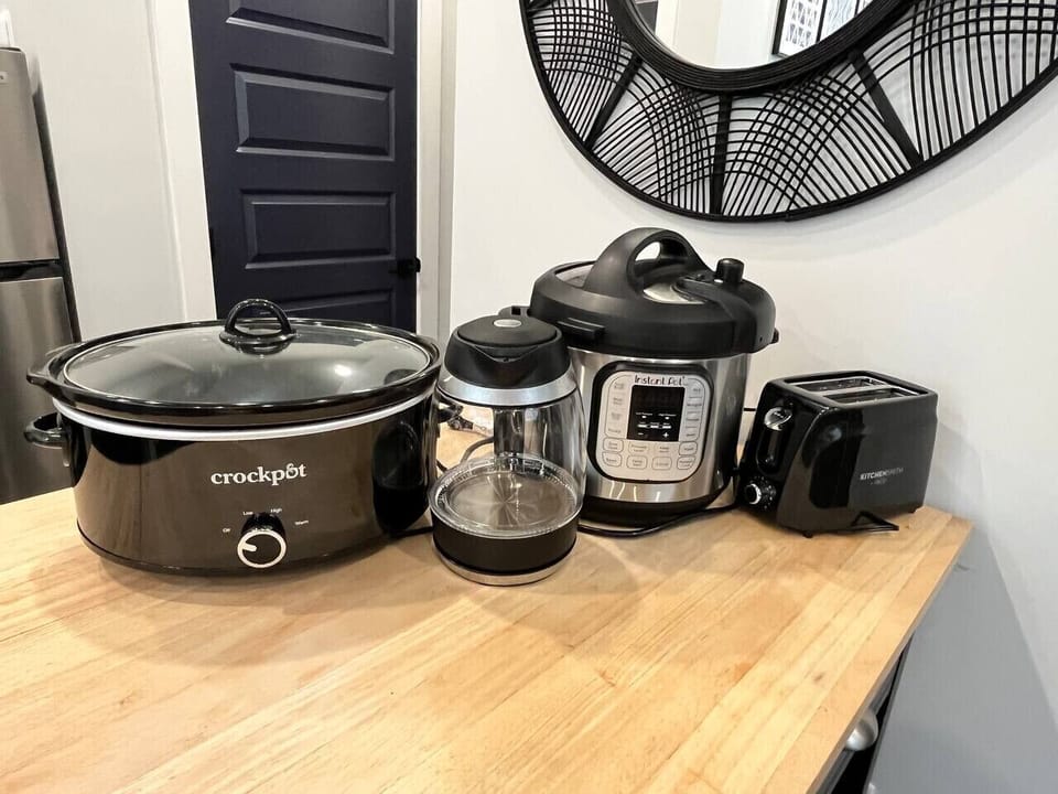 Variety of cooking appliances include an instant pot pressure cooker, slow cooker, toaster, induction water boiler, and a countertop induction stove burner