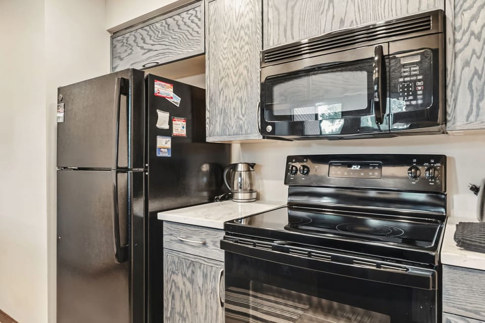 Kitchen: Main floor, drip coffee maker, blender, toaster, cooking utensils, tableware