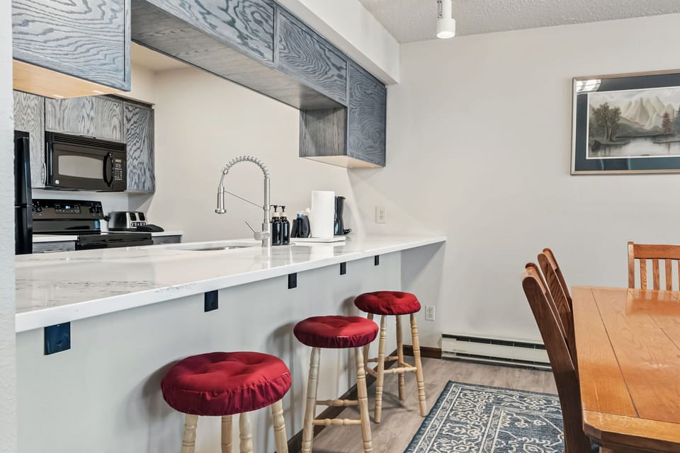 Kitchen: Main floor, drip coffee maker, blender, toaster, cooking utensils, tableware