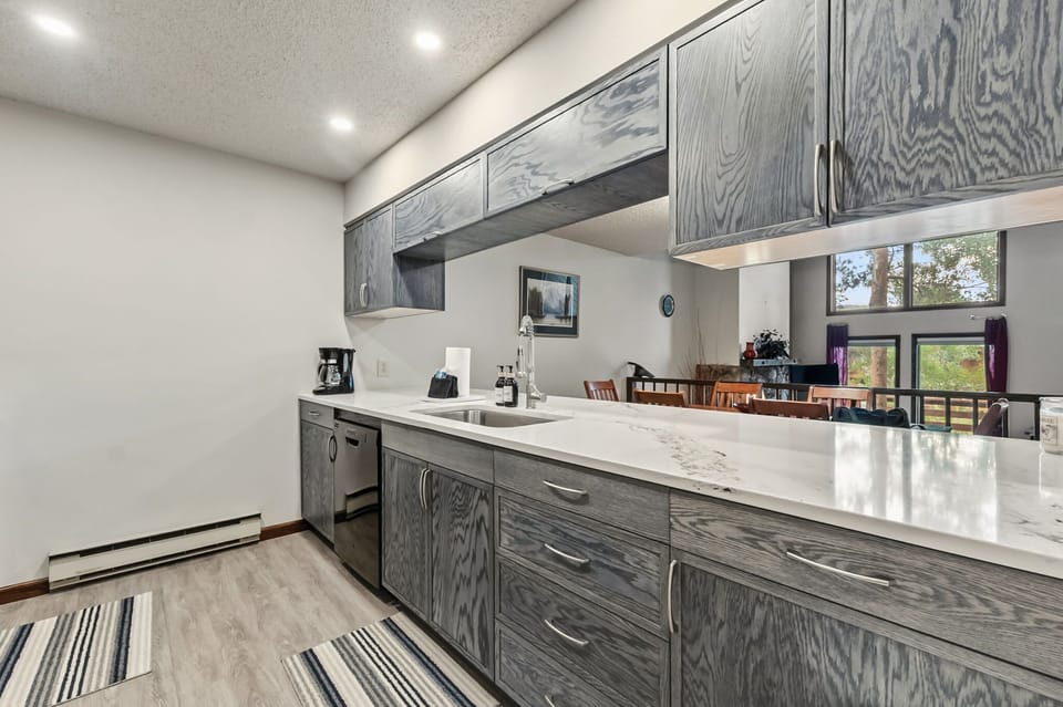 Kitchen: Main floor, drip coffee maker, blender, toaster, cooking utensils, tableware