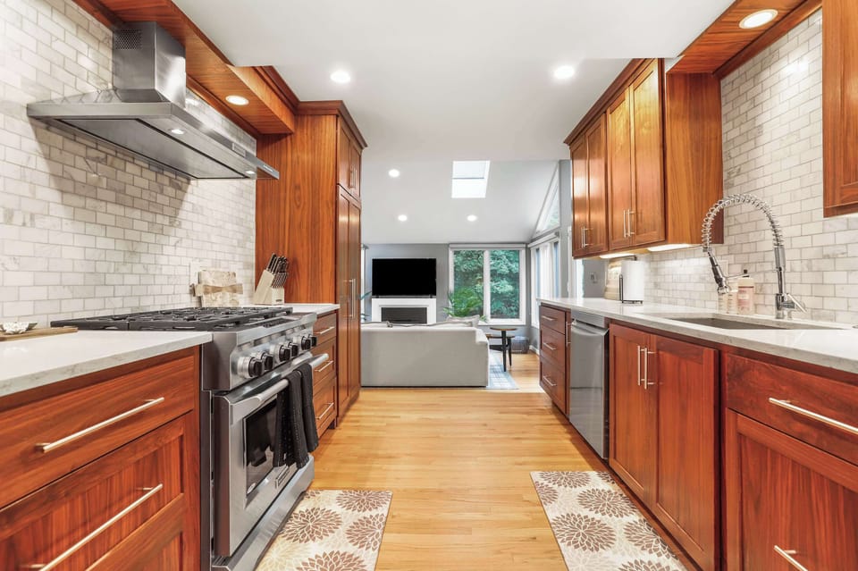 Full kitchen with view of middle level living room.