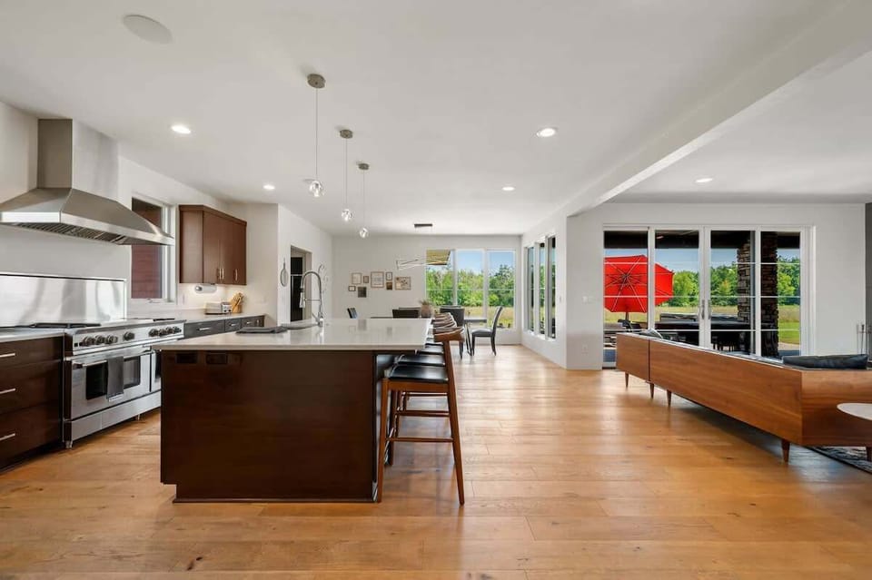 The expansive island provides additional seating and serves as the perfect centerpiece for cooking, entertaining, and connecting.