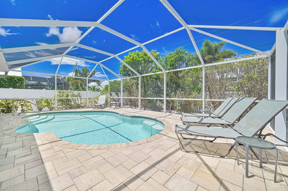 Coral Cove - Plenty of lounge chairs and seating around the private landscaped heated pool.