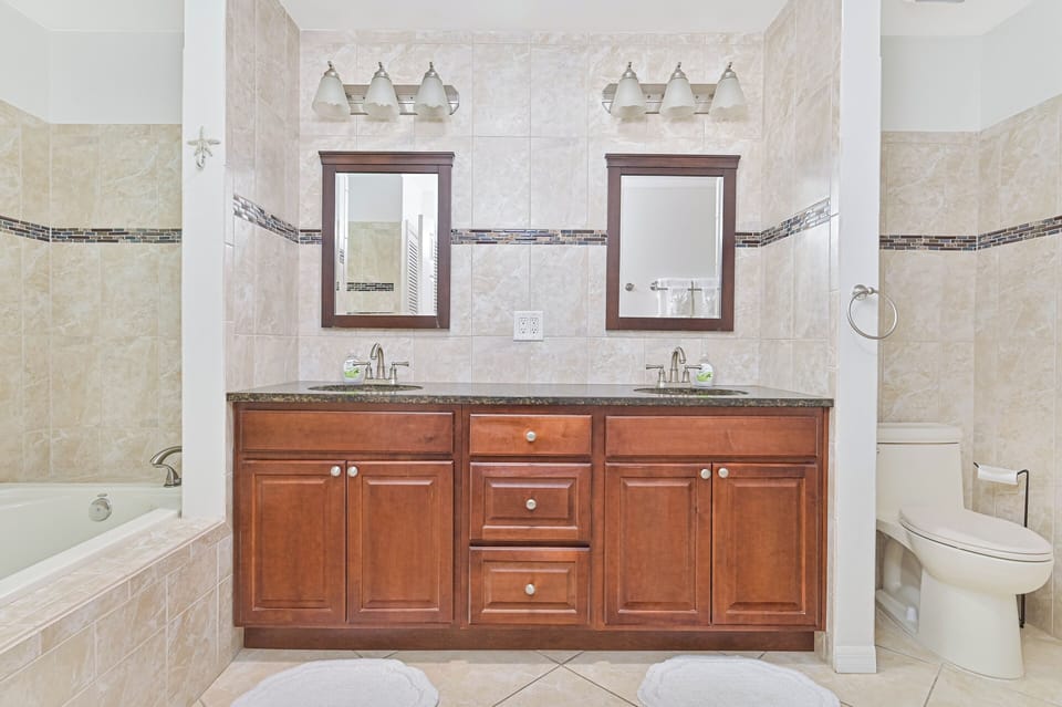 Coral Cove - The en-suite primary bathroom features double sinks, a soaking tub (not jetted), and a large walk-in shower