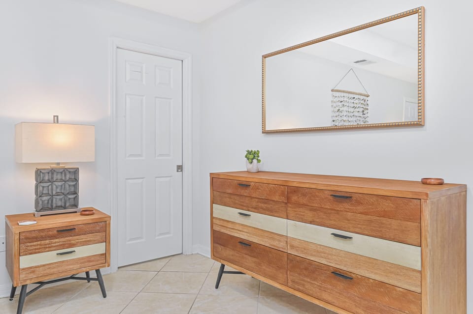 Coral Cove - A king size bed and smart TV and walk-in closet with hanging space in the primary bedroom