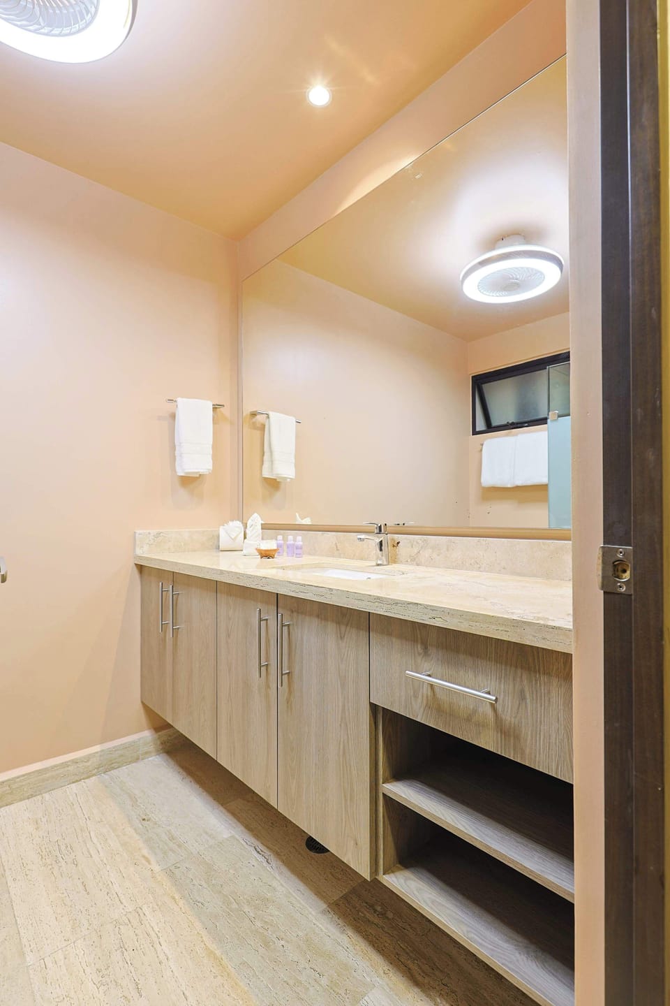 Spacious bathroom featuring a vanity sink for added comfort.