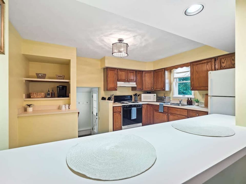 Bright kitchen with full appliances & breakfast bar seating—perfect for cooking & casual meals ☕✨